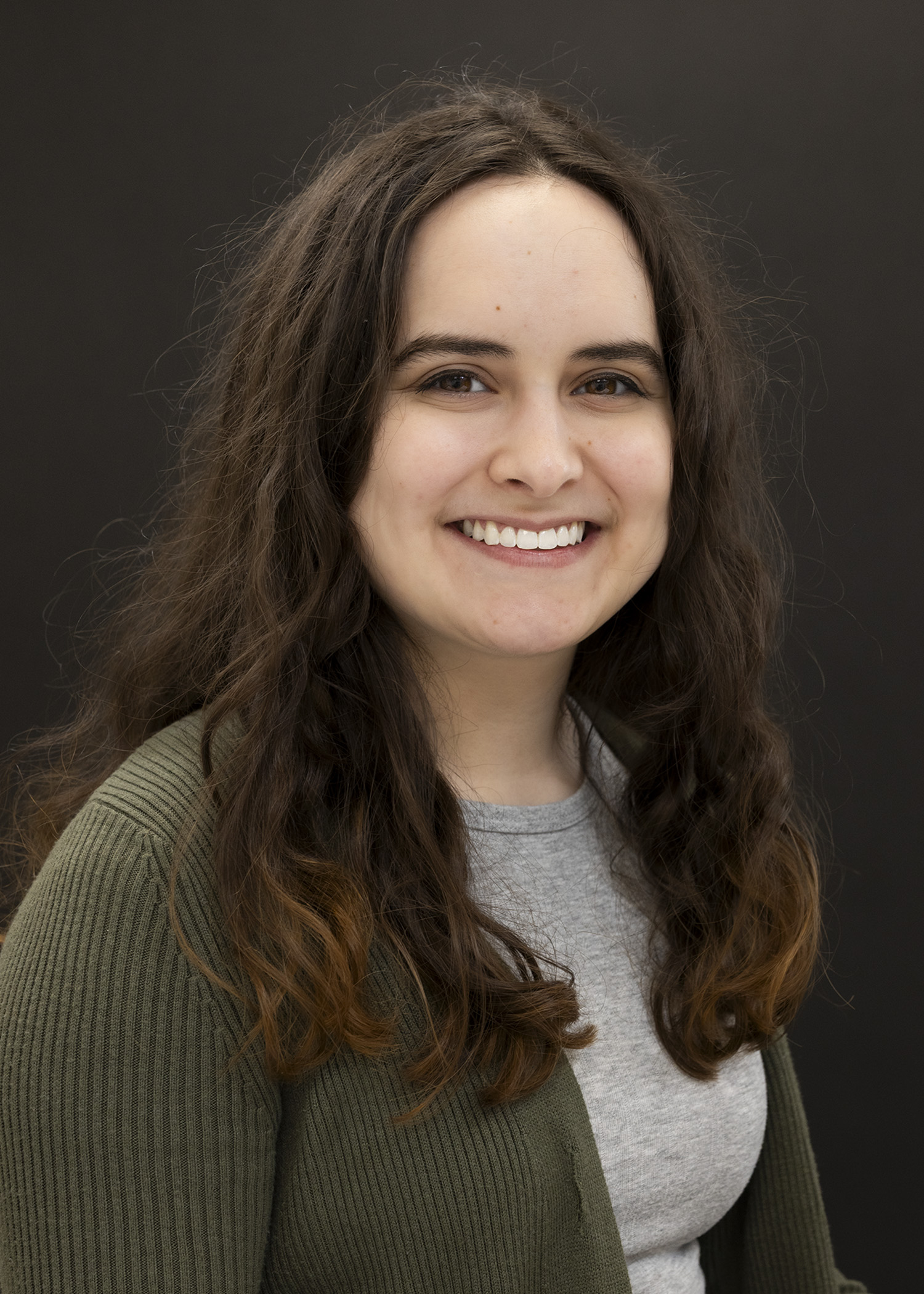 Headshot of woman with light skin and medium length dark brown hair